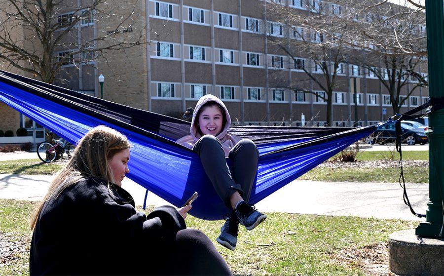 Sophomores Brittni Lawson, a pre-nursing major, and Sarah Fors, an elementary education major, talk with each other while hanging out Wednesday afternoon in the South Quad outside of Taylor Hall. Lawson said it was nice to get out and enjoy the weather.