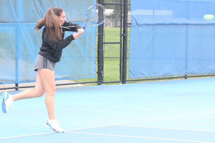 Rachel Papavasilopoulos hits a back-handed shot in the middle of a volley with Emily Pugachevsky during practice at the Darling Courts in October 2018.