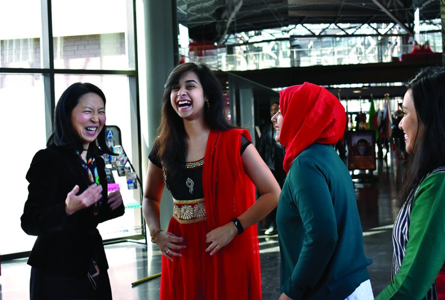 Jinhee J Lee, a professor of history, coordinator of Asian Studies and the main organizer for Asian Heritage Month, talks with students during the Kick-off Reception in the Doudna Concourse of the Doudna Fine Arts Center on Monday afternoon.