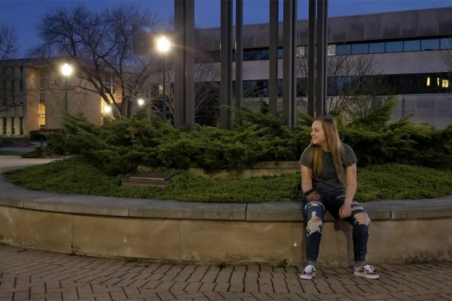 Kara Price, a junior graphic design major, enjoys the weather while it lasts in front of the Booth Library. She says her favorite part about the nice weather was grilling and spending time outside with her friends.