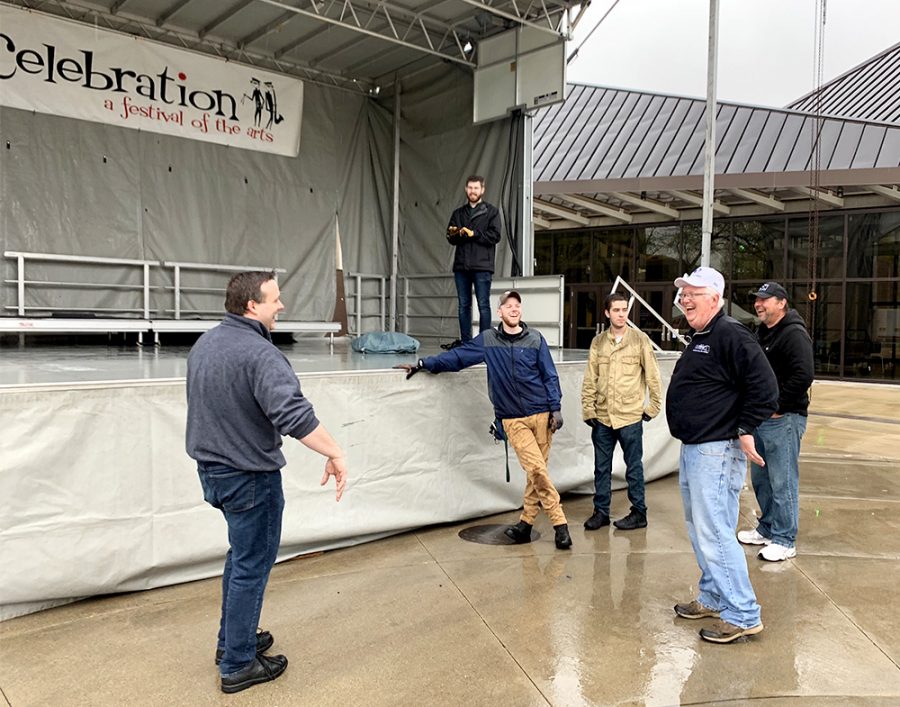 People talk to each other while they finish setting up the concert stage for Celebration a Festival of the Arts Thursday afternoon outside of The Doudna Fine Arts Center. Alverson Sound Inc. was contracted to build the stage by Z’s Music & Sound.