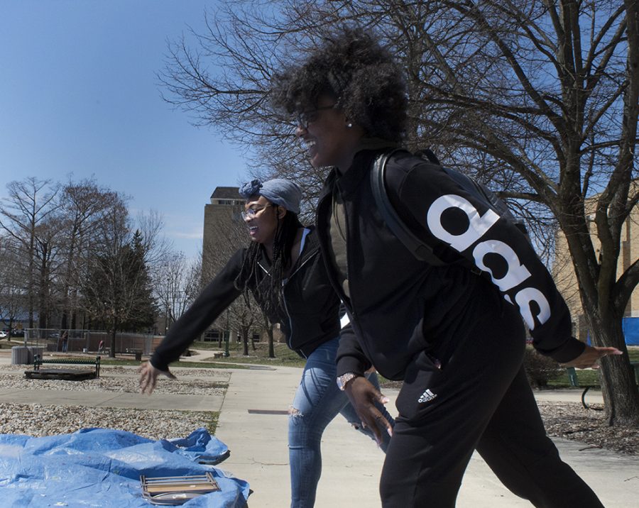 KJ Weah, a criminal justice major, and Jordan Streeter, a pre-medical biology major, break tiles at Breaking Stereotypes at the Library Quad on Tuesday.