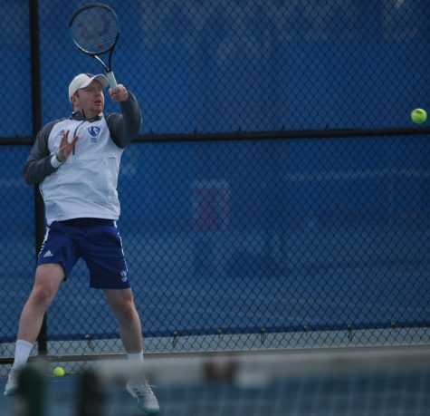 Freddie O’Brien returns a hit with a forehand hit of his own in his singles match during Eastern’s 6-1 loss to Jacksonville State March 22 at the Darling Courts.