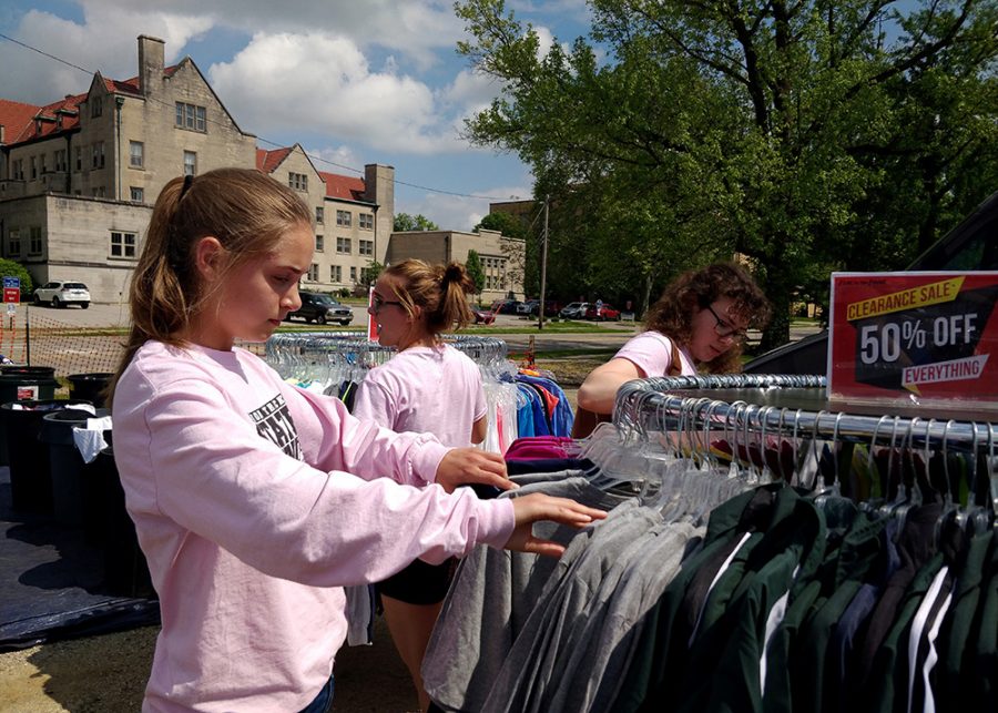 Hayley Vanduyne, a freshman from Orion High School, shops with her teammates Wednesday afternoon at First To The Finish, a set of merchant tables located at an empty space next to Arby’s. 