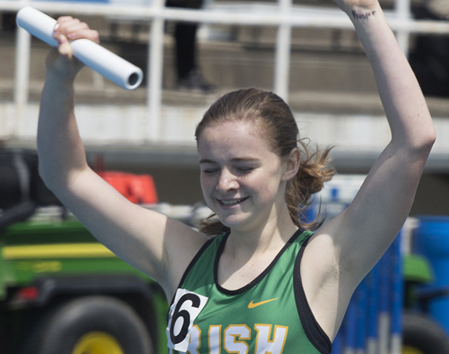 Sophomore Amber Vroman from Seneca High School throws her arms up in celebration as she crosses the finish line during a preliminary heat of the 4x800 meter relay, solidifying her squads first-place finish in the heat Thursday at OBrien Field during the Illinois High School Associations Girls Track and Field semifinals.