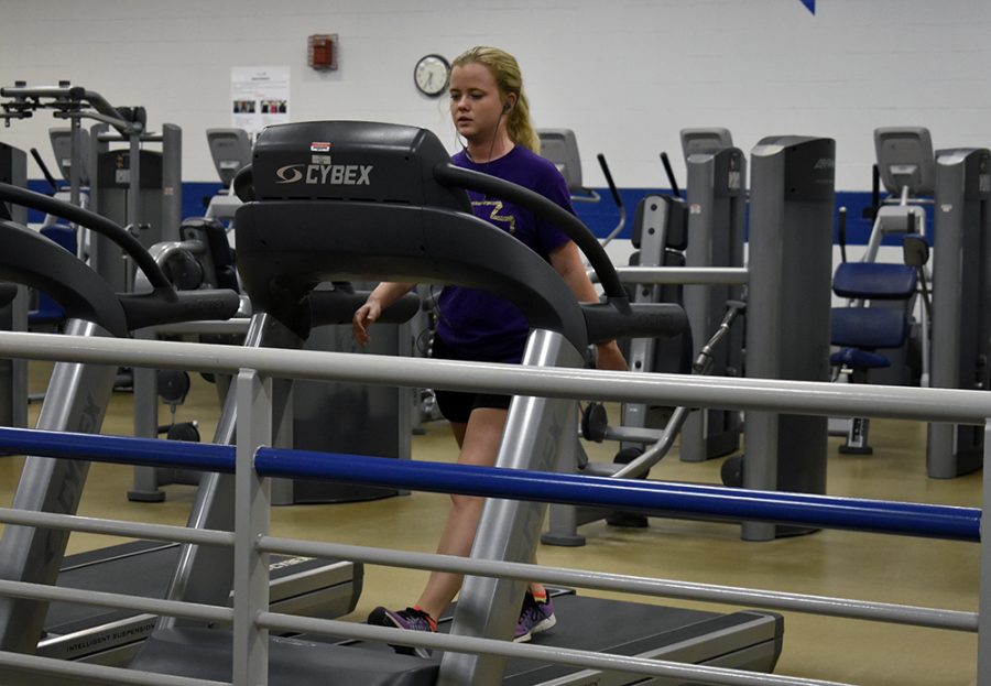 Leslie Hearn, a communication disorders and sciences graduate student, walks on a treadmill Wednesday afternoon in the second floor of the Student Recreation Center. 