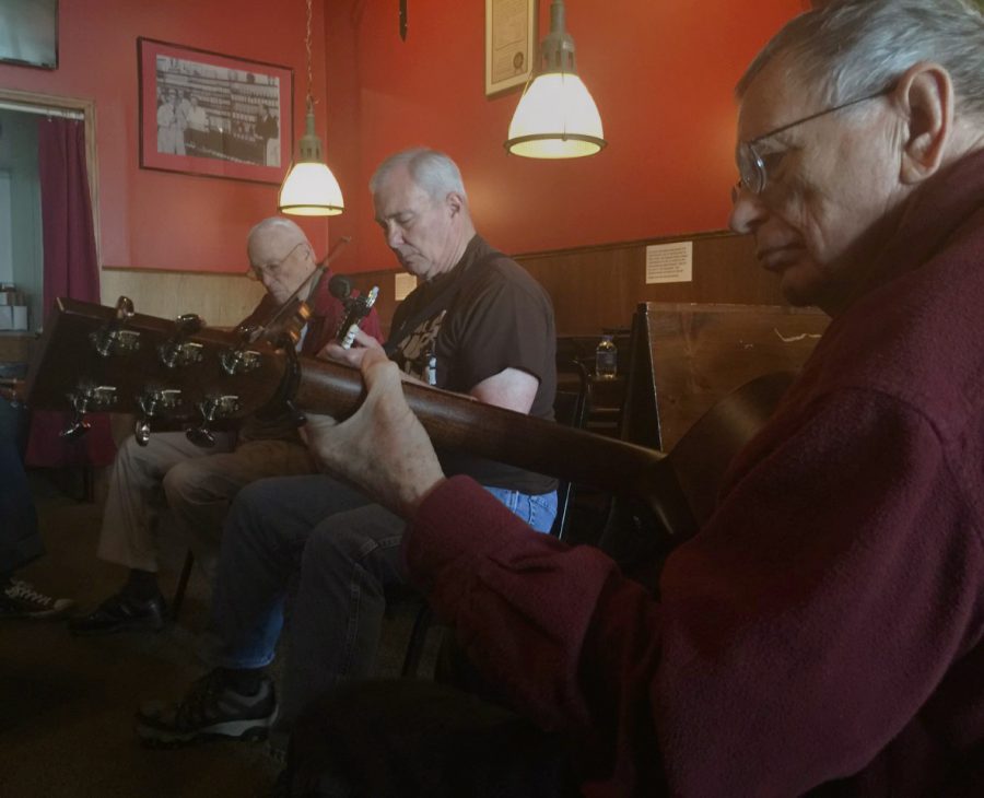 Jerry Ellis (right), an acoustic guitar player from Charleston, plays old-time tunes from Dear Old Illinois with Jim Jand (middle), a banjo player from Tolono, and Jerry Myers (left), a fiddle player from Mattoon, at Rocs Blackfront Tavern & Grill Sunday afternoon.