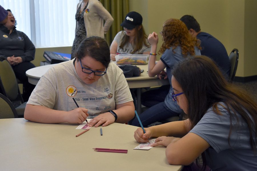 Rosa Coit (left), a sophomore from Charleston High School, colors patterns on a coloring sheet during Celebrate Pride at the Rotary Room of the Charleston Carnegie Public Library on Monday afternoon.