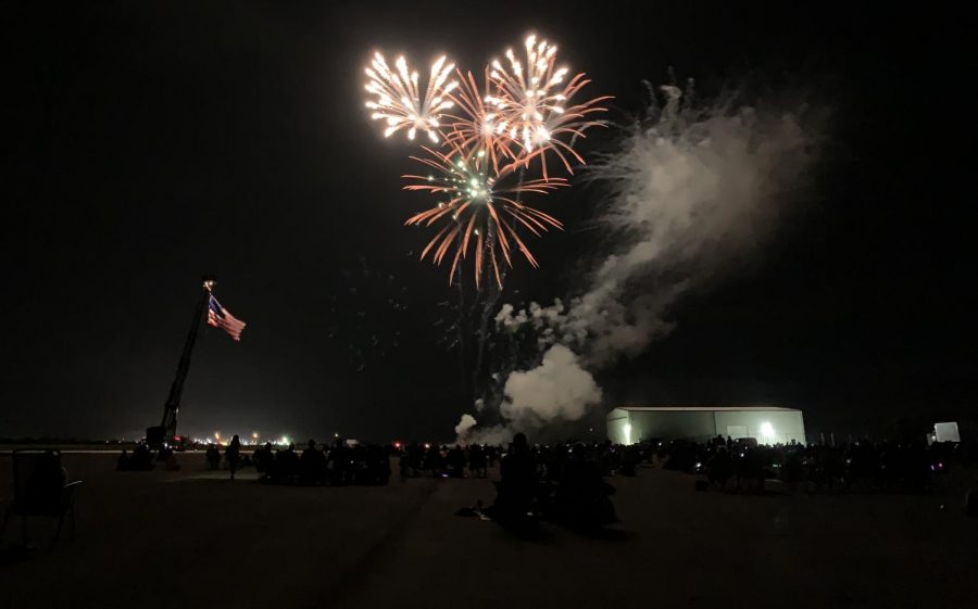 People watch as the fireworks finale takes place at the Cole Coles County Airport during the Fourth of July celebration.