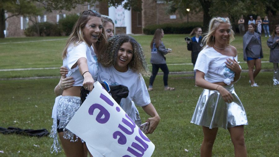 Alaina Grosvenor (middle), a junior nursing major, welcomes sisters home during Bid Day Sunday evening. “(Recruitment is) really exciting and overwhelming, but I’m super excited for our new babies in Sigma Kappa.”