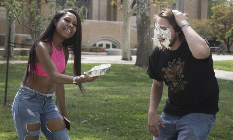 Summer Jacobs | The Daily Eastern News
“How should I smack you?” asked Armoni King, a sophmore bussiness and marketing major, before pushing a pie into Mikey Meyer’s face, who is a transfer music education major, at the Library Quad on Tuesday afternoon. 