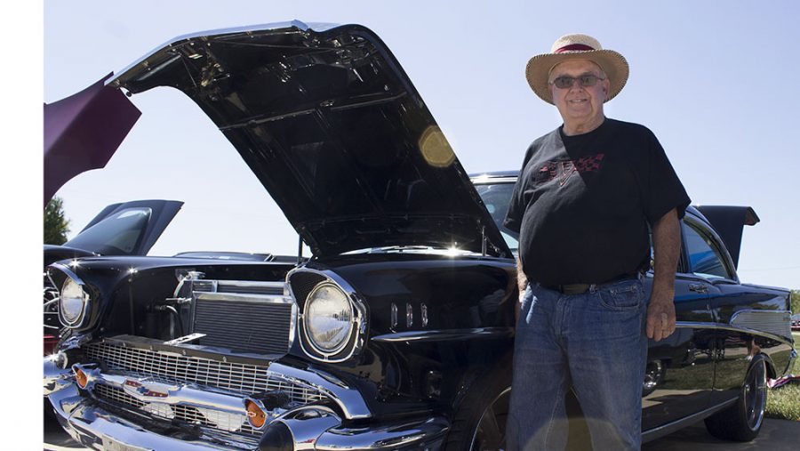 Dick Bulter, of Mattoon, stands with his 1957 Chevy Bel Air at “Can’t Drive 55” car show. Butler said his favorite thing about owning an old car is to anwser questions people may have.