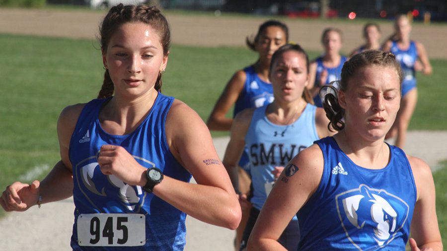 Tom O’Connor | The Daily Eastern News
Teammates Katie Springer (left) Sarah Carr (right) run together ahead a small pack of runners in a 5K race. Springer finished 11th and Carr finished 10th in the event at the EIU Walt Crawford Open Sept. 6.
