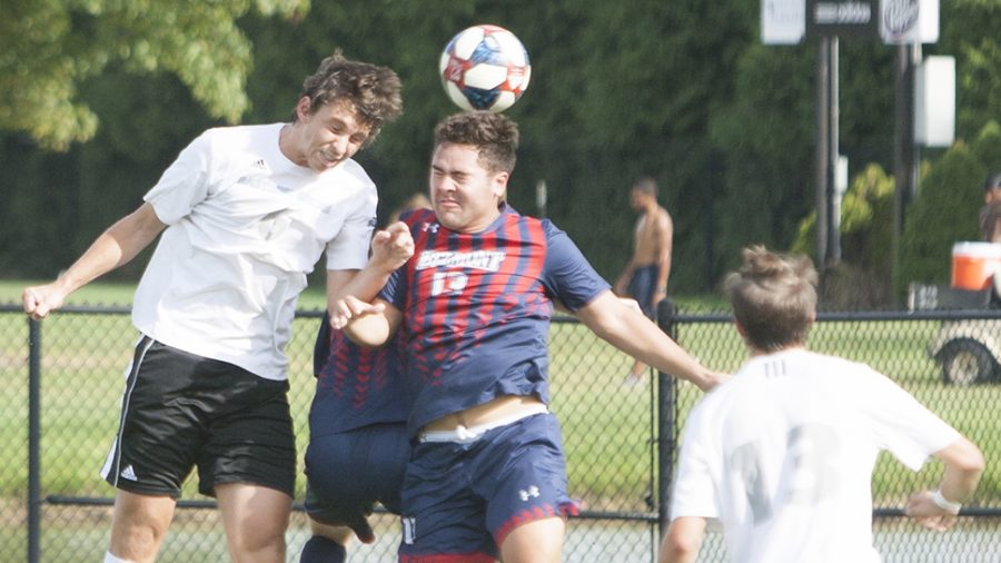 Dillan Schorfheide | The Daily Eastern News 
Davi Girardi heads a cross toward Belmont’s goal as a defender jumps with him. Girardi scored the game-winning goal in overtime to give Eastern a 3-2 win over Belmont Tuesday at Lakeside Field.