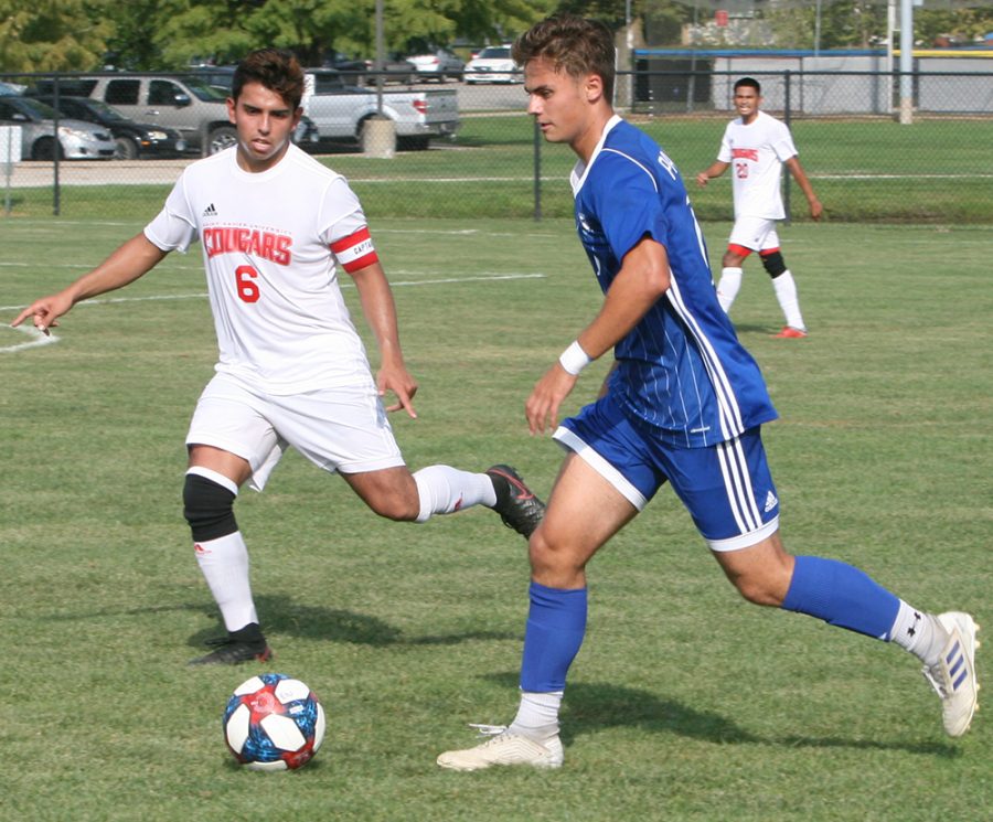 Karina Delgado | The Daily Eastern News
Chrisitan Sosnowski dribbles the ball as a defender guards him. Eastern defeated St. Xavier 2-0 Tuesday at Lakeside Field in the team’s season opener.