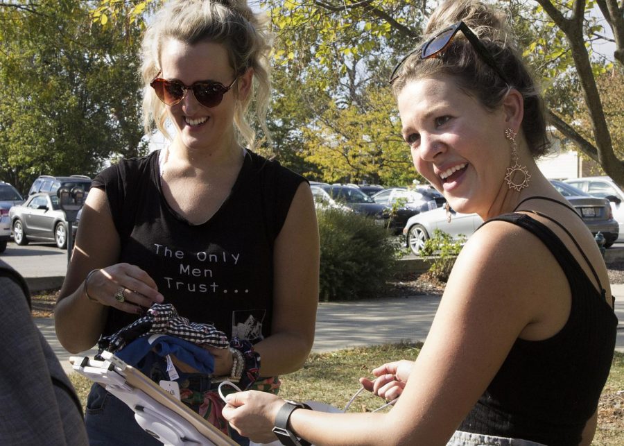 The owners of Brick and Motor Fashion Boutique, Lauren Corwin (left) and Haley Walker (right), scan and bag a student’s purchase from their mobile boutique in front of Booth Library on Tuesday afternoon. “We’ve been in business a year, and we pretty much do the best when we go sit outside colleges. We go to, like, sororities and partner with them because we give back 5 percent of our sales to their philanthropy, so we always do, like, fundraising. They usually invite us on parents weekend or philanthropy week — it’s Alpha Phi’s week, so that’s why we’re here.”