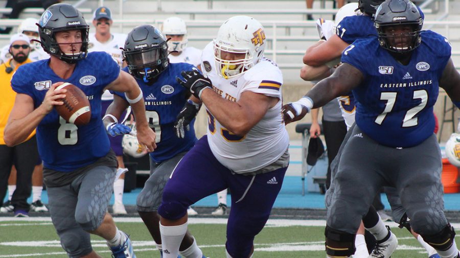 Adam Tumino | The Daily Eastern News
Harry Woodbery scrambles around the pocket while looking downfield to look for an open receiver. Eastern lost to Tennessee Tech 40-29 Sept. 28 at O’Brien Field.