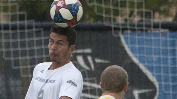 Matheus Santos tries to head a ball past a defender, who is looking on. Eastern lost 2-0 to Milwaukee Tuesday at Lakeside Field.