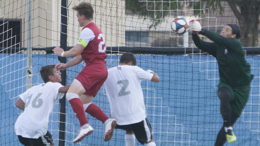 Dillan Schorfheide | The Daily Eastern News
Jonathan Burke punches a crossed ball away as an attacker misses his header attempt. Eastern defeated IUPUI 1-0 Oct. 1 at Lakeside Field.