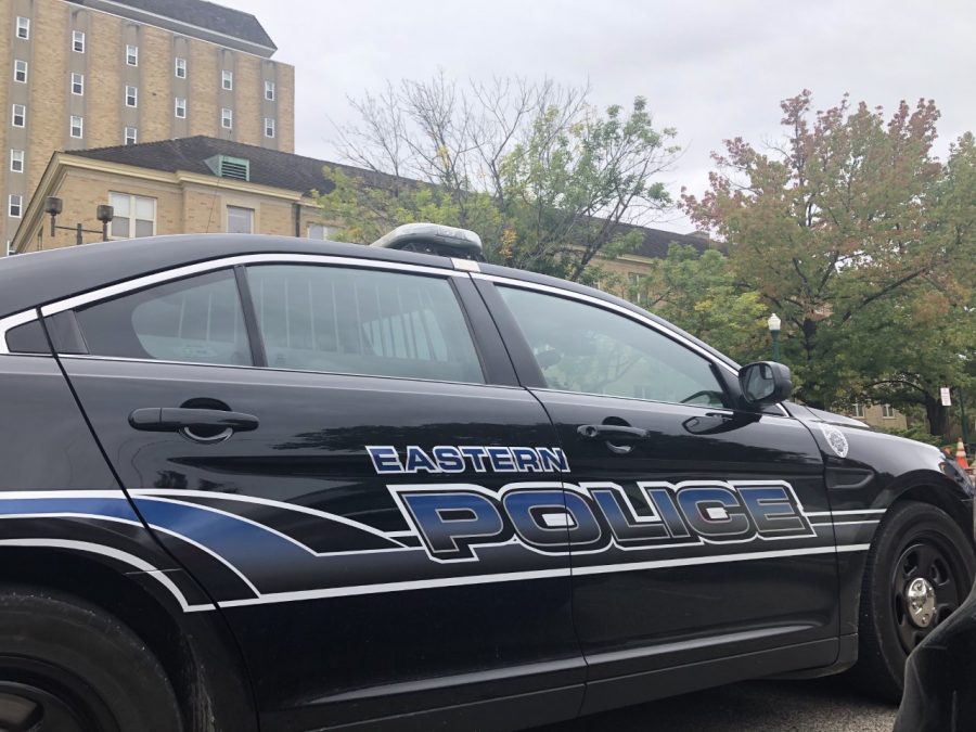 A police car sits outside Douglas Hall Tuesday morning after law enforcement responded to a report of a gun in the building. No gun was found. 