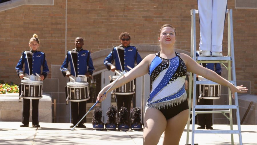 Cassie McCleery, a senior majoring in family consumer science with a focus in education, twirls during a Library Quad performance before a September football game.