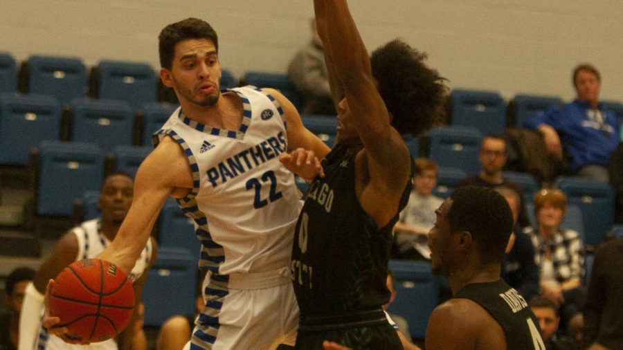 Eastern guard Josiah Wallace wraps a pass around a Chicago State defender in the game Nov. 12 in Lantz Arena. Wallace had six points, three rebounds and three assists in the Panthers’ 98-34 win. 