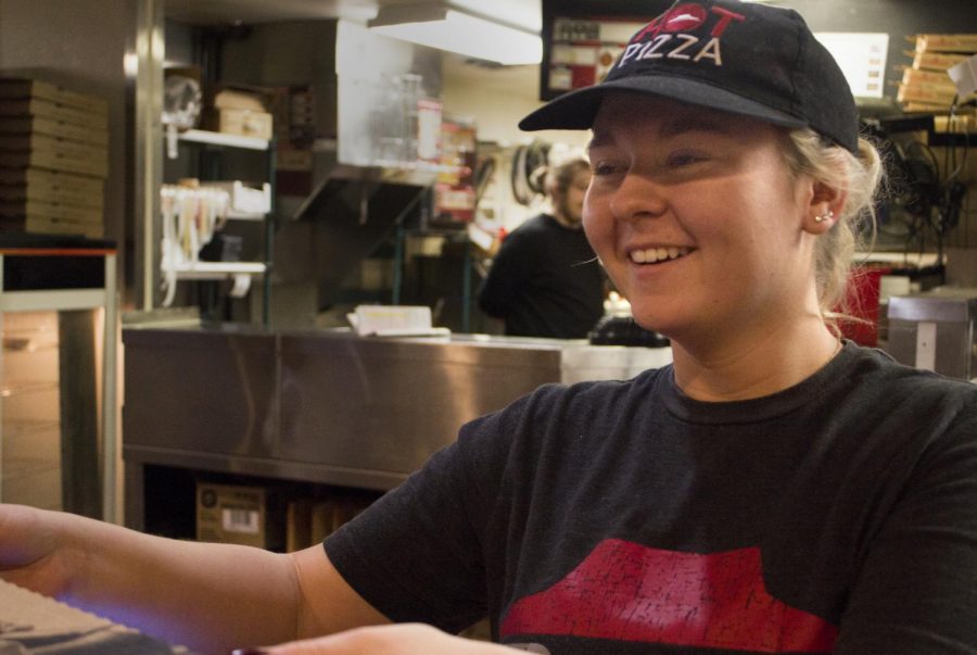 Mylissa Greenawalt, a sophomore special education major, gives two customers their pizza at Charleston’s Pizza Hut Sunday afternoon. Greenawalt said she stayed in Charleston during Thanksgiving break to work at Pizza Hut. 