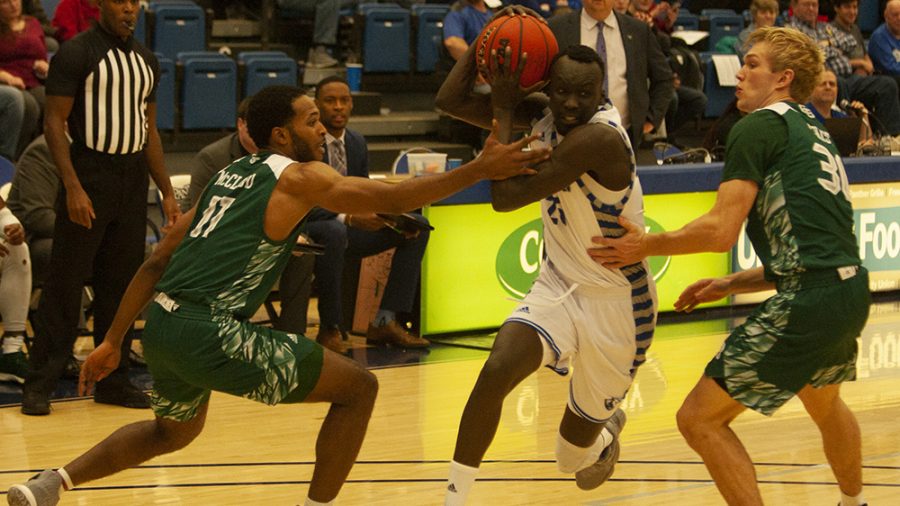 Adam Tumino | The Daily Eastern News
Eastern guard Deang Deang drives between two Green Bay defenders Dec. 7 in Lantz Arena. Deang had 12 points, five assists and four rebounds in the game, a 93-80 win for Eastern.