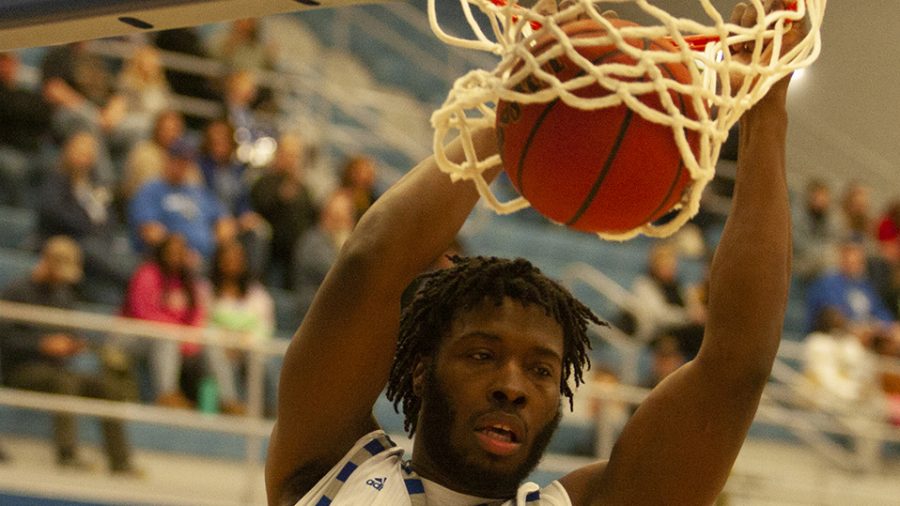 Adam Tumino | The Daily Eastern News
George Dixon hangs on the rim as he slams down a two-handed dunk. Eastern defeated Tennessee Tech 84-59 Jan. 18 in Lantz Arena.