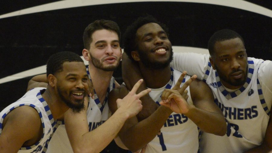 Members of the Eastern mens basketball team (from left) Shawn Wilson, Josiah Wallace, Kashwan Charles and JaQualis Matlock celebrate an 83-80 overtime win against Austin Peay Feb. 22 in Lantz Arena. 