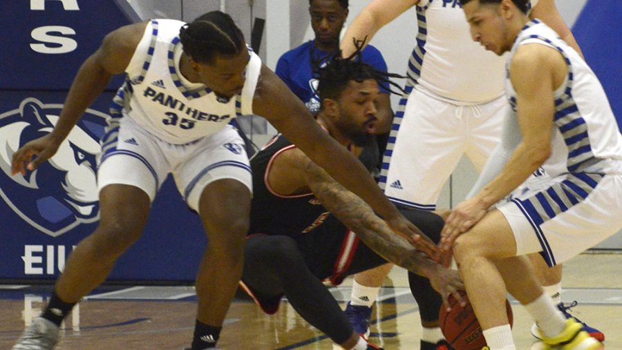 George Dixon (left), Logan Koch (middle) and Shareef Smith (right) surround an Austin Peay ball handler and reach in for a steal during Eastern’s 83-80 victory over Austin Peay Feb. 22 in Lantz Arena. Eastern can secure an OVC tournament spot with a win Thursday against Southeast Missouri.