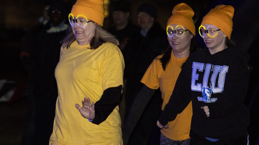 Three women from the Minion team prepare to jump into the water during the 2020 Polar Plunge, which is an annual fundraising event to support Special Olympic Athletes at Eastern’s pond on Sunday night.