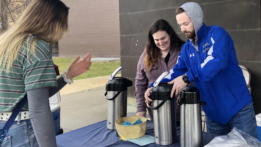 Bayleigh Grimes, junior music education major, and Josh Thor, senior management major, represented Eastern’s Christian Campus House as they gave out flyers and free hot chocolate in front of the Doudna Fine Arts Center on Monday morning. 