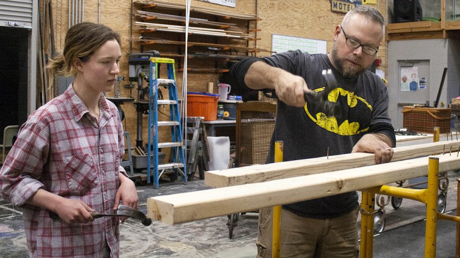 Emma Walker, a senior theatre arts major, and Christopher Gadomski, a theatre arts professor, technical director, and scene shop foreman, remove nails from a board that was used in a previous show in the Doudna Fine Arts Center at the scene shop on Monday afternoon.