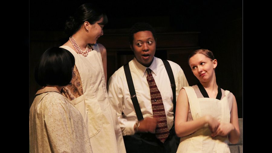 Catherine (far left), played by junior theatre major Merri Bork, Pearl (left), played by a senior theatre arts major Ellen Lee, Francis, played by junior vocal performance major Lucy Hill, talk to Mr. Reed, played by junior theatre major Ty Patterson, as he introduces Catherine to the other girls at Radium Corp. during dress rehearsal for These Shining Lives at the Doudna Fine Arts Center in The Theatre.