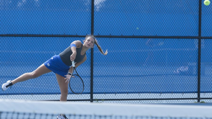 File Photo | The Daily Eastern News
Claire Perez-Korinko serves the ball over the net to her opponent. Eastern’s women’s tennis team lost two matches over the weekend.