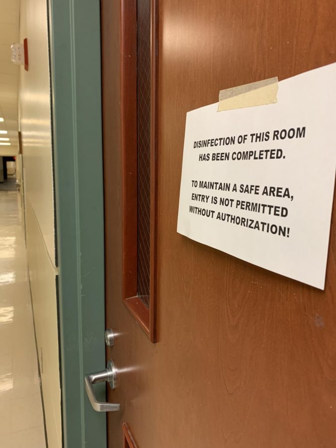 A poster hangs on the door of Room 1842 of Buzzard Hall Wednesday that explains any entry is not allowed unless authorized. Building service workers are sanitizing Eastern as a result of the COVID-19 pandemic. 