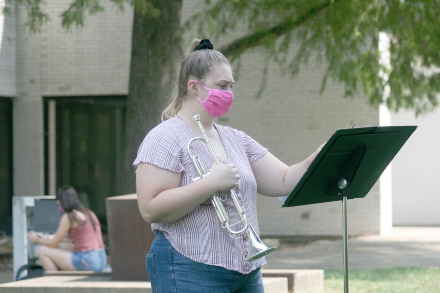 Mikayla Ruot,a junior music education major, practices for social distance wind symphony. Ruot said she still has to wear mask while playing but the mask has a slit in it so she can still play her trumpet. 