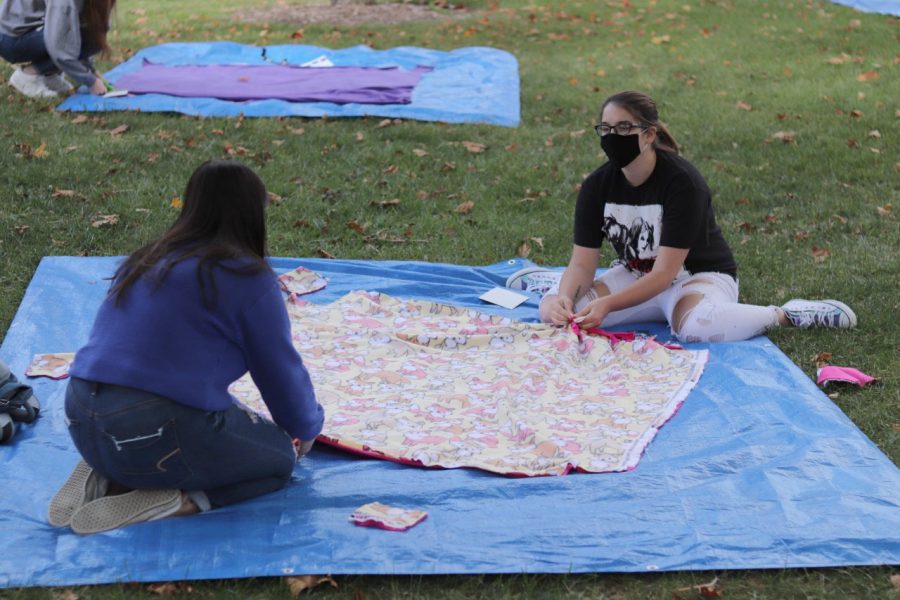 Hope Folk (left), a freshman communications major, and Cheyenne Hollowell (right), a freshman history education major teamed up with Civic Engagement to make blankets for those in need on the Library Quad Tuesday afternoon.