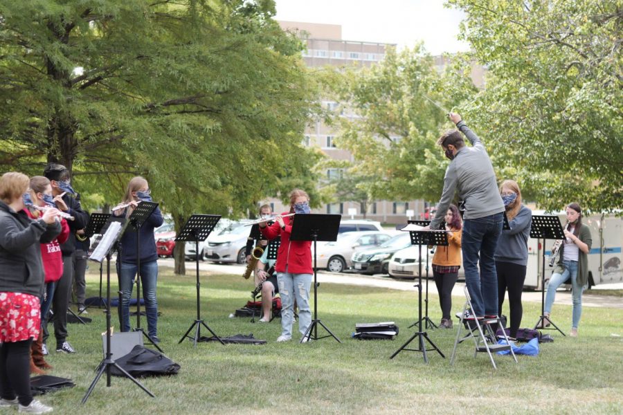 A group of Eastern music students participate in an outdoor rehearsal outside of Tarble Arts Center Tuesday afternoon.