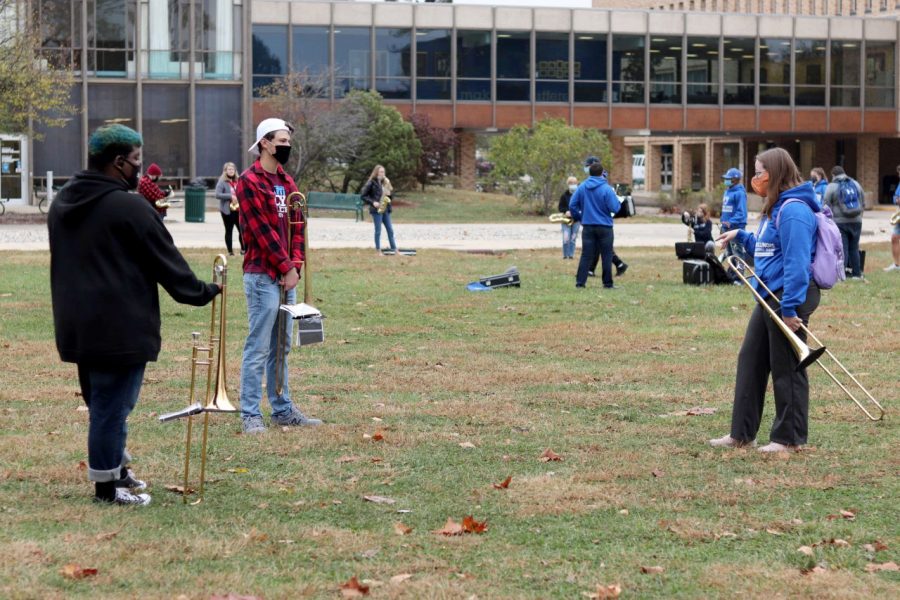 From left to right: Sean Hayes, a sophomore music education major, Lucas Grindley, a freshman broadcast journalism major and Savanna Wooten, a sophomore music education major, prepare for rehearsal on the Library Quad Wednesday afternoon.