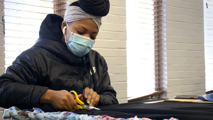 Cyan+Carter%2C+a+sophomore+psychology+major+and+double+minor+in+services+and+entrepreneurship%2C+spends+her+time+Wednesday+afternoon+making+no-sew+blankets+for+a+local+community+charity.