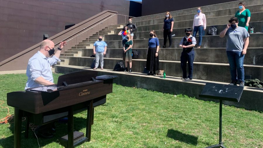 Andrew Martin, choral conductor, conducts concert choir class on the Mellin Steps on March 21, 2021. Martin explained because singing is an aerosol activity and COVID protocols only a group of ten can sing inside. Now the group can expand because they can sing outside in the warm weather.