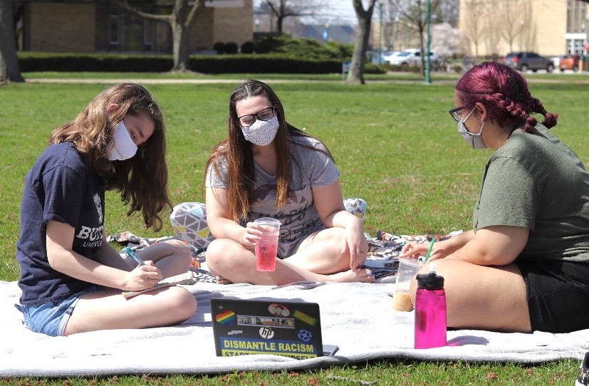 Katie Webb, a junior english major, Jaclyn Thomas, a junior communication major, and Katryna Wilkes, a junior political science major sit on the south quad listening to music and doing sudoku puzzles while enjoying the weather Sunday.