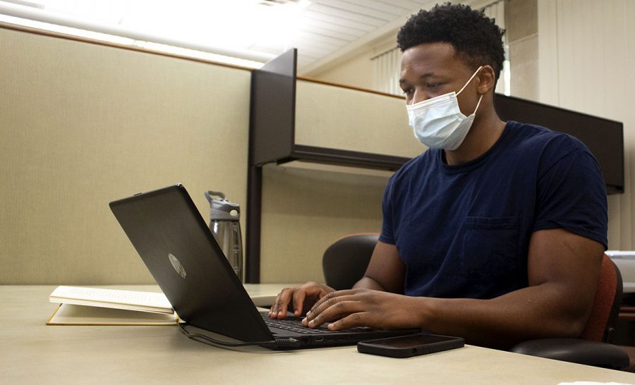Tadiwanashe Mhinga, a business analytical major, works on his laptop at the Center for Student Innovation desk in Booth Library Monday afternoon. The CSI desk will be open Monday through Friday from 10am to 5pm.