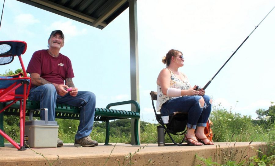 James Willenborg and Jennifer Odell wait for fish to bite their lines at Lake Charleston.  Odell said they havent gotten any bites or caught any fish Wednesday afternoon.