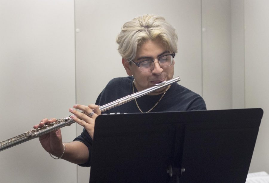 Issac Navarro, a junior music performance major, practices the flute.