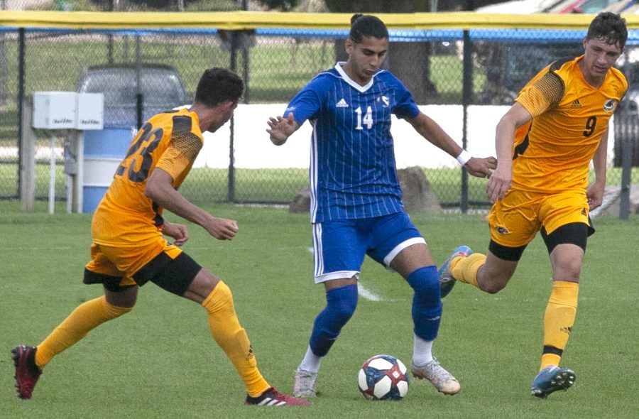 Eastern redshirt-junior midfielder Munir Sherali tries to keep the ball away from two Milwaukee players in a match Aug. 30 at Lakeside Field. The score was tied 0-0 at halftime when severe storms forced the match to be declared a no-contest. 