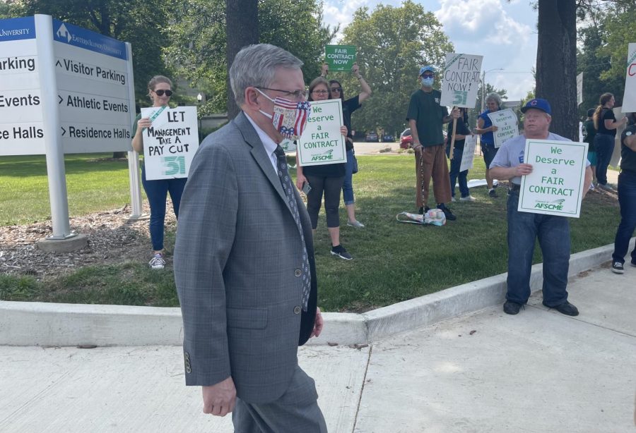 Eastern Treasurer Paul McCann walks down Lincoln Avenue on Aug. 19, crossing the paths of protesters seeking a contract for members of The American Federation of State, County and Municipal Employees Local 981. 