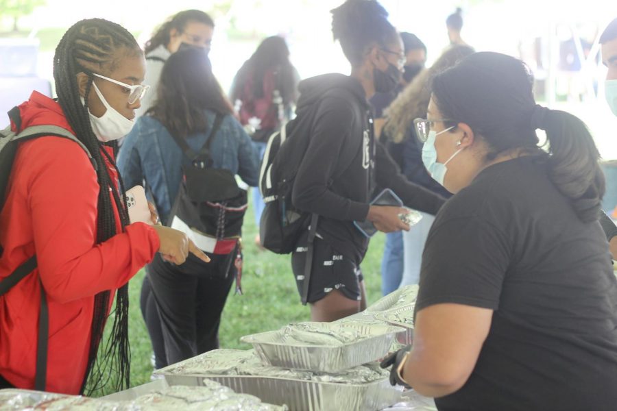 Brejona Hutchinson, a sophomore majoring in computer and information technology, enjoys Latino Heritage Kickoff by waiting in line for a taco. 